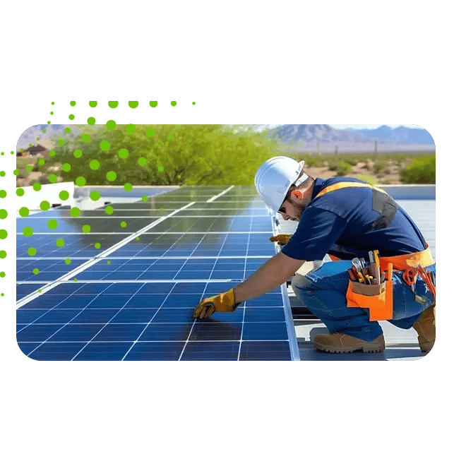 A technician in a hard hat works on a solar panel array on a rooftop with a desert landscape in the background. A technician in a hard hat works on a solar panel array on a rooftop with a desert landscape in the background.